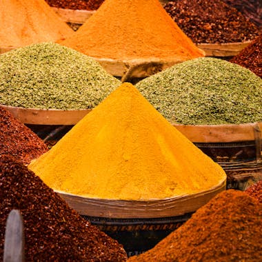 A colorful array of spices displayed in a traditional Istanbul market, showcasing rich flavors and textures.